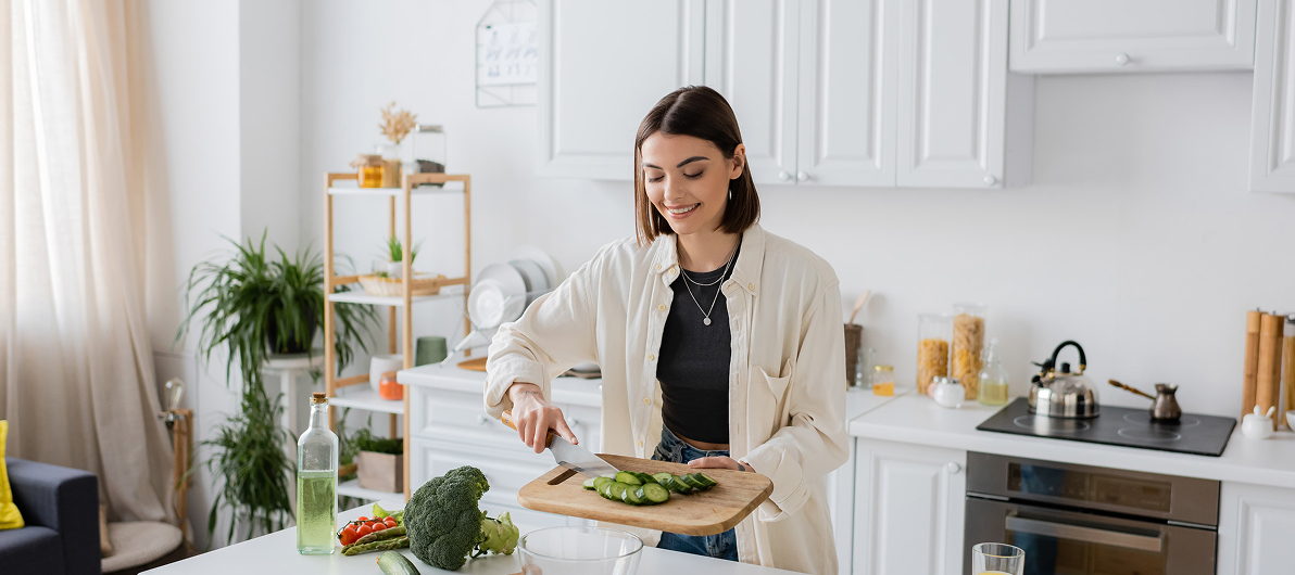 Woman preparing food on cutting board