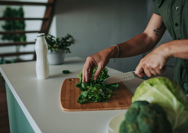 Woman preparing food on cutting board